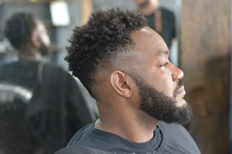 Side profile of a client with a fresh skin fade and full beard at Blackwolf
